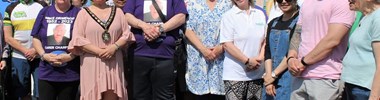 Norman standing with other volunteers at a community event