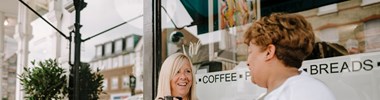 Smiling woman having a conversation in a cafe