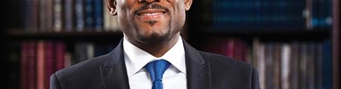 smiling man wearing a suit